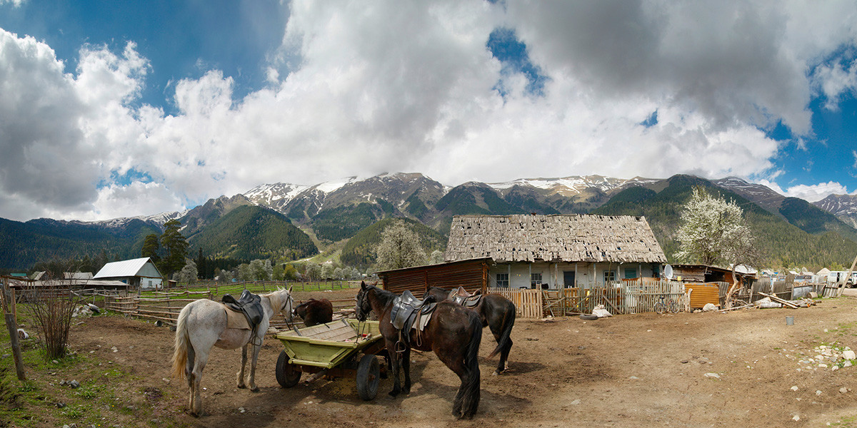 Arkhyz mountain resort in summer with green alpine valley and snow-capped Caucasus peaks