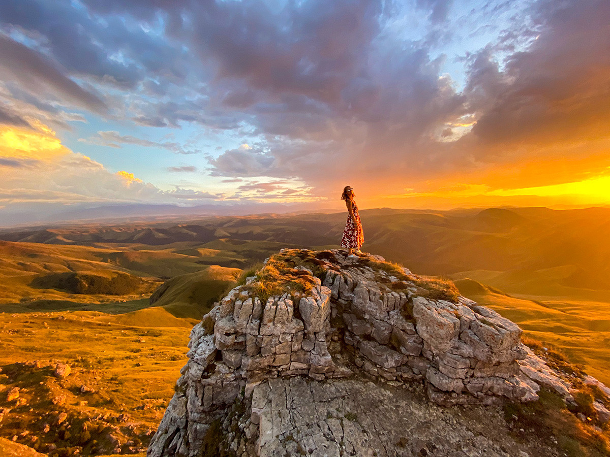 Dramatic sunrise over the Bermamyt Plateau with rock formations and sea of clouds