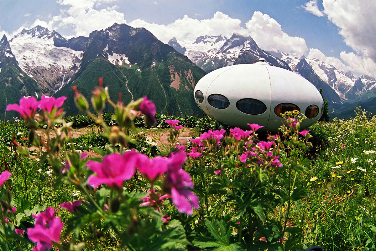 Dombay ski resort with cable cars, mountain lodges, and snow-capped Caucasus peaks