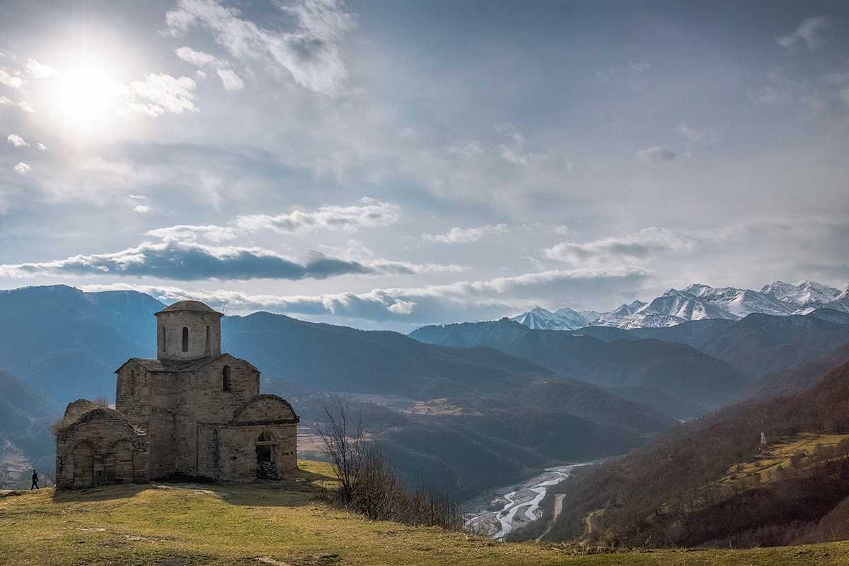 Ancient 10th-century Sentinsky Byzantine church on cliff overlooking Teberda River valley