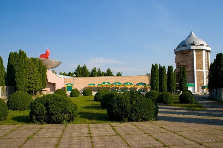 Sosruko restaurant shaped like Nart hero head with torch on Mount Kizilovka cliff in Nalchik