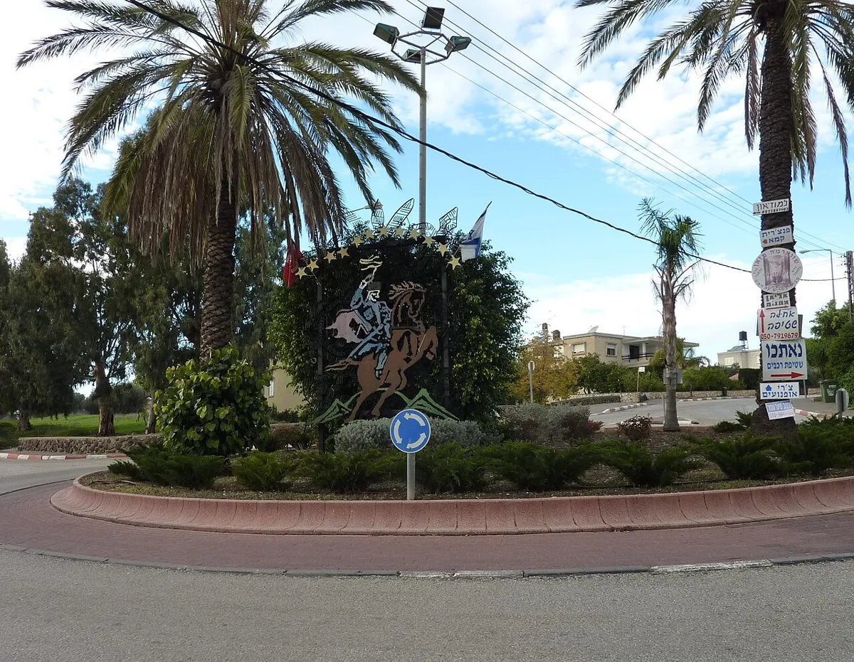 Roundabout in Kfar Kama with a metal sculpture of the Nart hero Sosruko on horseback among palm trees